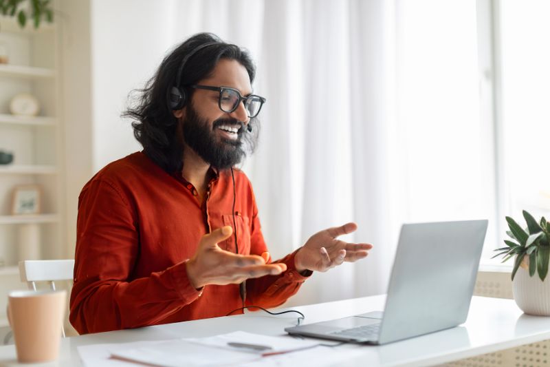 Young man on a video call working from home; exploring legit ways to make money online as a first-time online earner.
