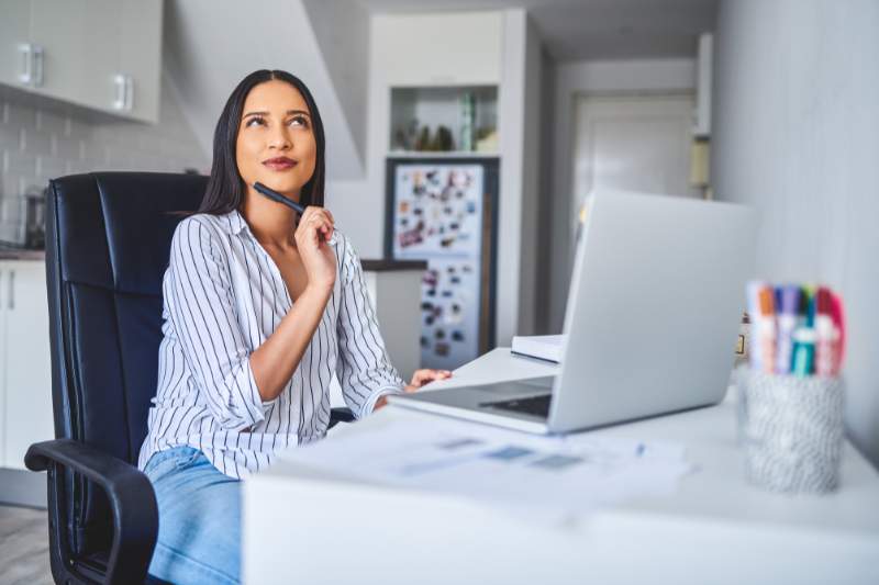 Woman thinking about benefits of HSA vs FSA.