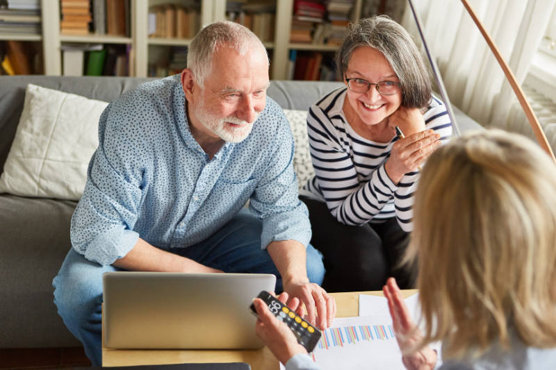 Senior couple discussing qualified charitable distributions with a financial advisor