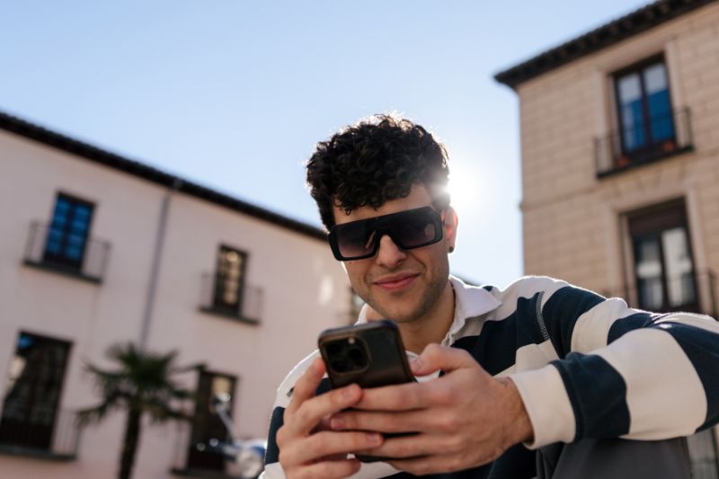A person using tax preparation software on their smartphone to e-file taxes, highlighting the convenience and efficiency of e-filing for taxpayers.