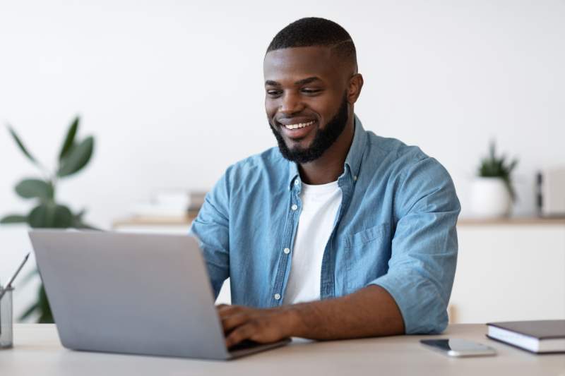 Man using laptop to research tax-deductible expenses for tax filing.
