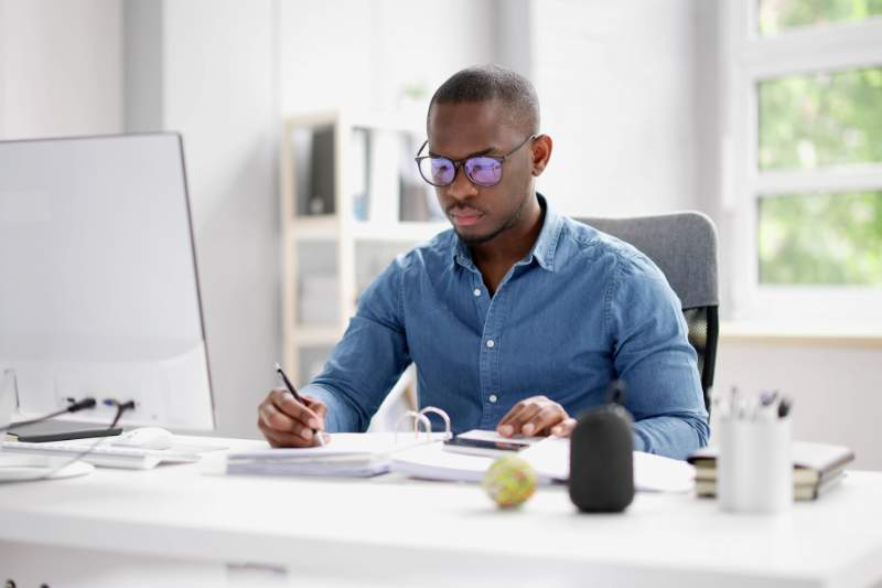 Man doing accounting, reviewing types of retirement accounts.